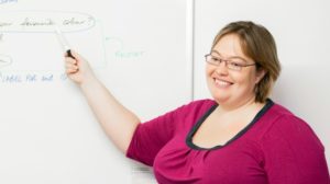 Gian pointing to a whiteboard